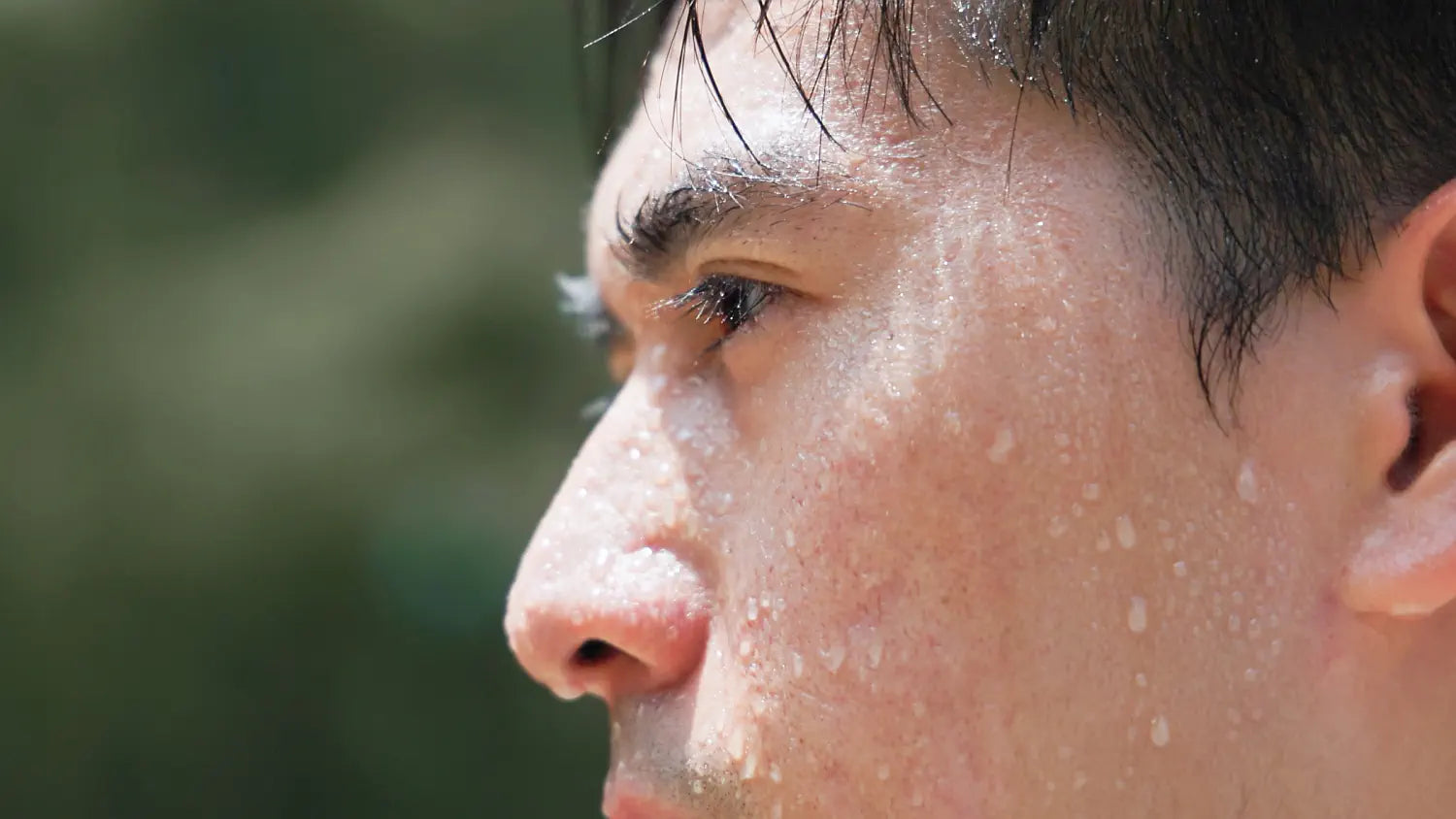 Athlete sweating during exercise in hot conditions, illustrating fluid and electrolyte loss.
